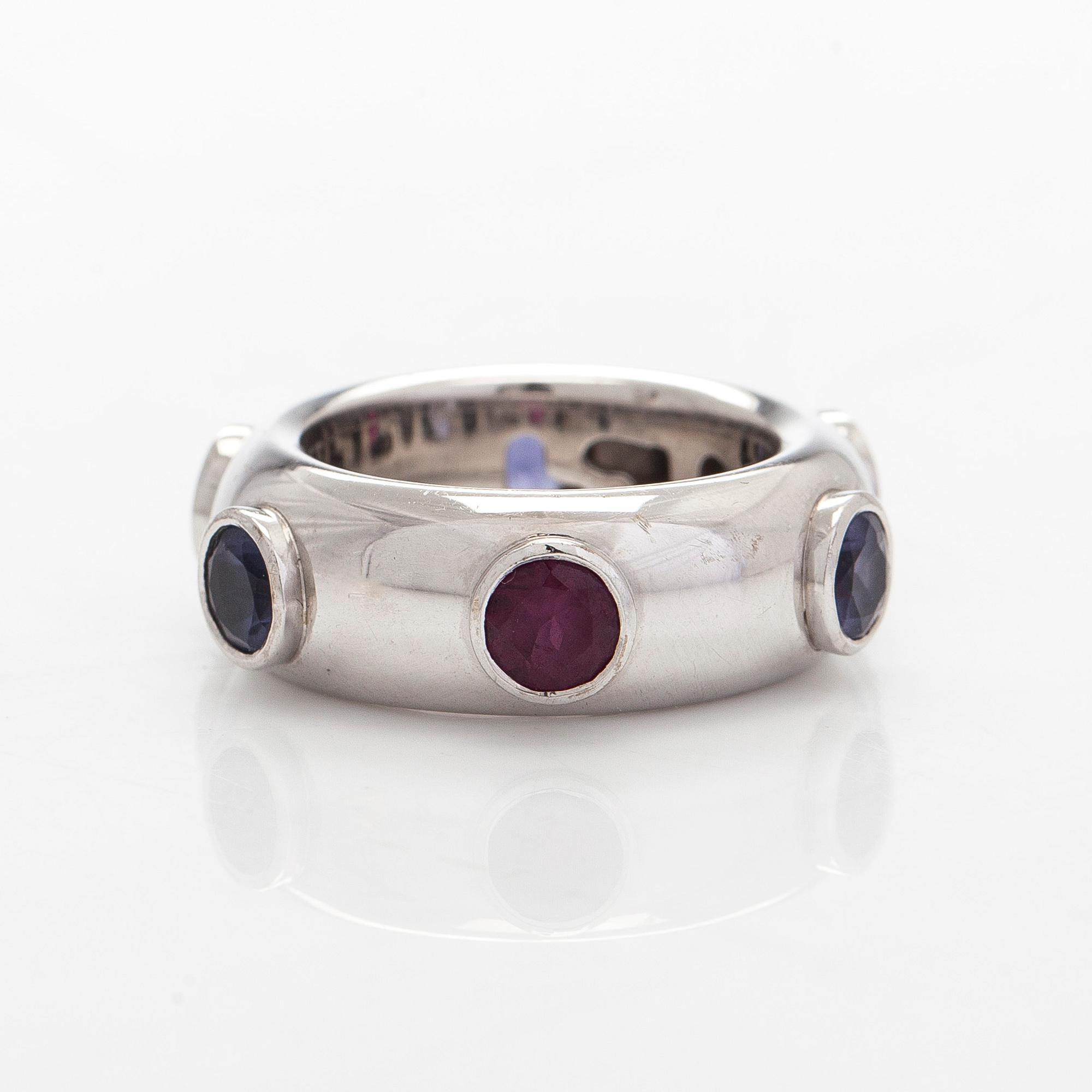 An 18K white gold ring with garnets and cordierites.