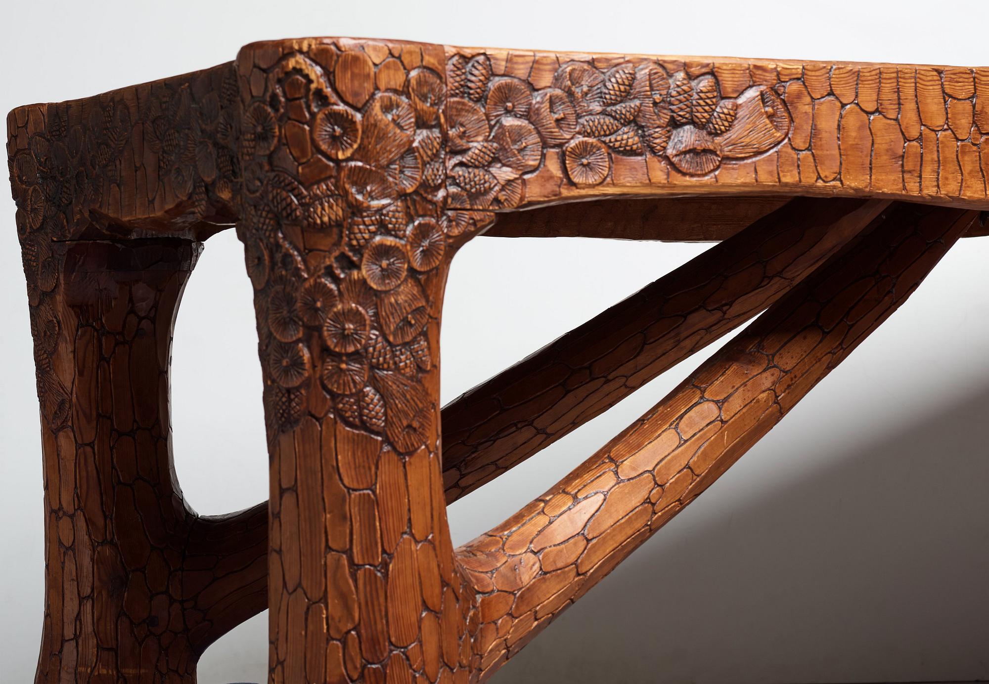 Gustaf Fjaestad, an Art Nouveau carved pine table, Arvika Sweden 1914, a double to the table in the Thiel Collection,