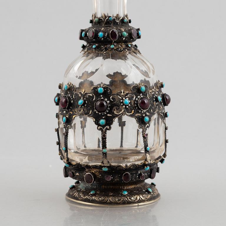 Flask with stopper, glass with mounts of partially gilded silver, late 19th century.