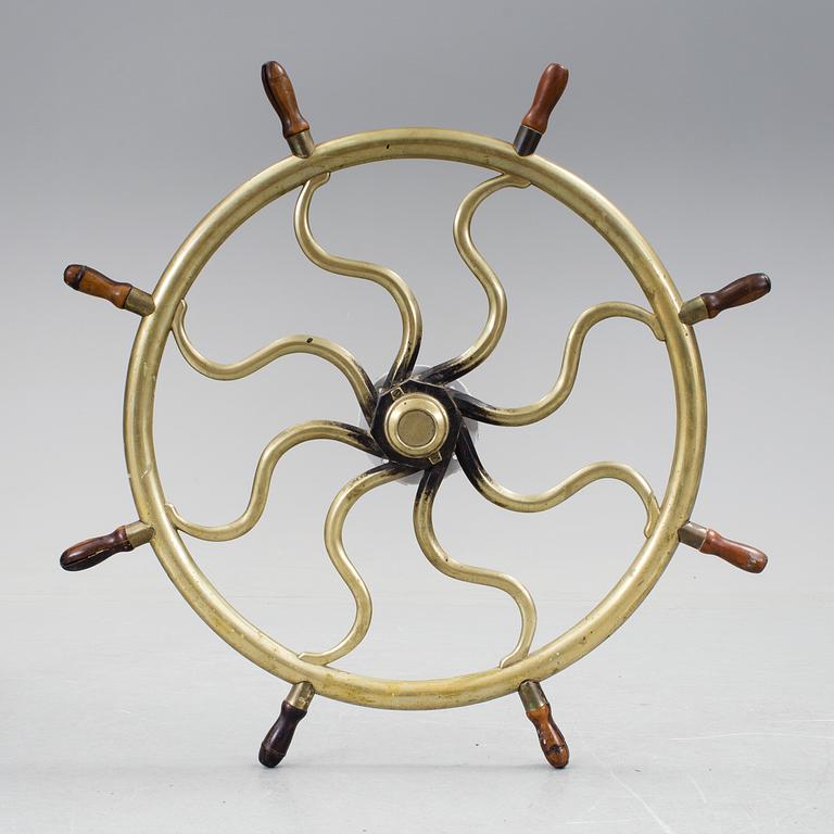 A ship steering wheel, about 1900.