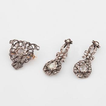 A pair of earrings and a brooch set with rose cut diamonds.