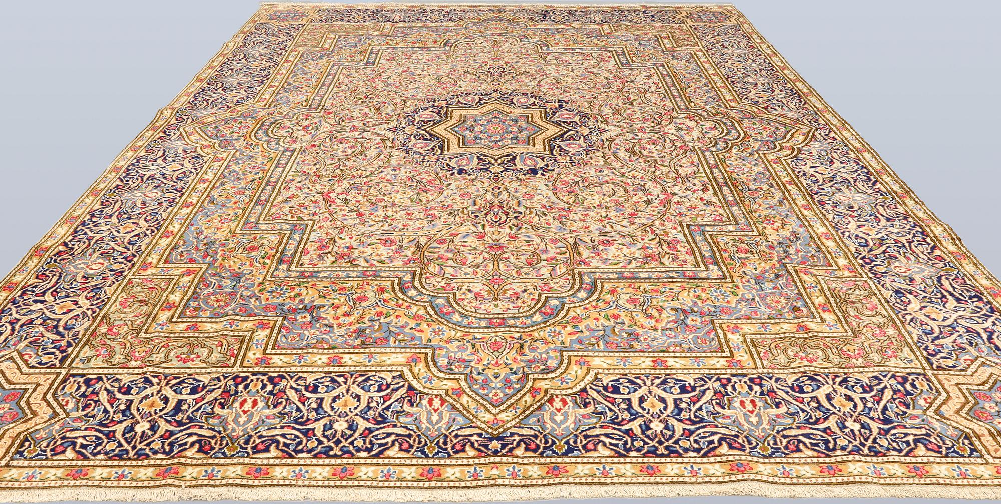 A Kirman Laver carpet, 'Millefleur', approx. 410 x 296 cm.