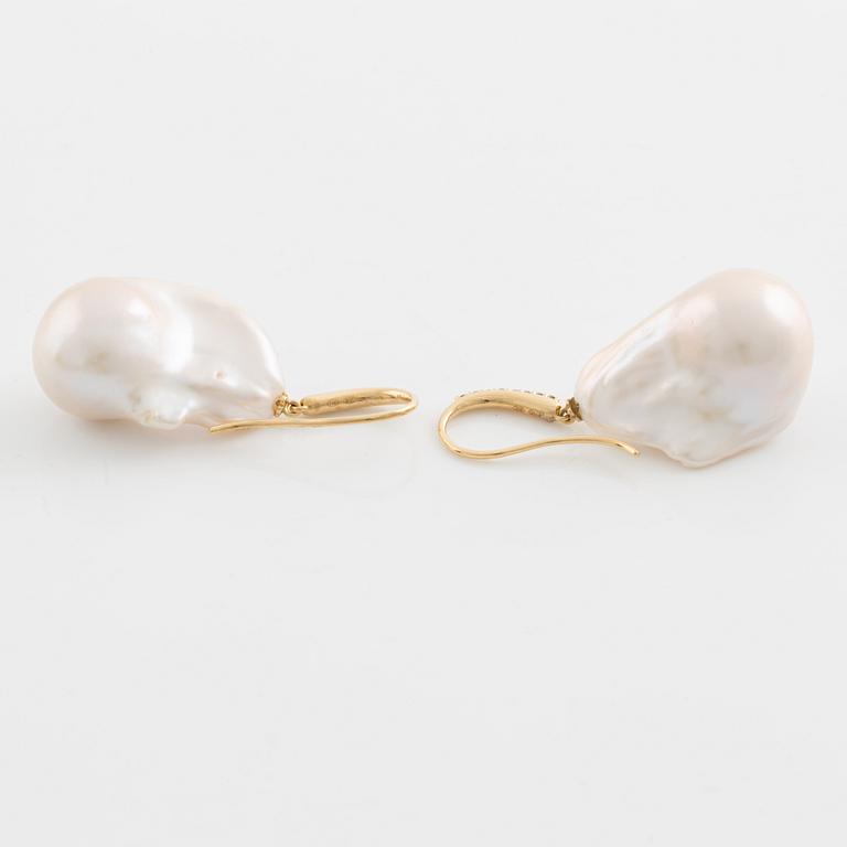 Cultured freshwater pearl and brilliant cut diamond earrings.