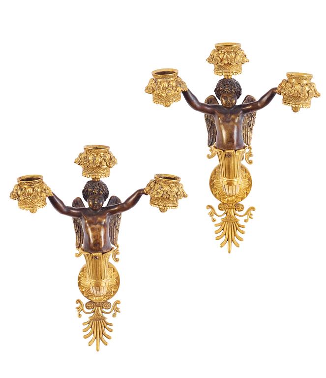 A pair of Empire early 19th century three-light wall-lights.