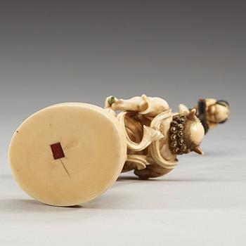 A Japanese Ivory okimono with inlays of mother of pearl and wood, Meiji period (1868-1912).
