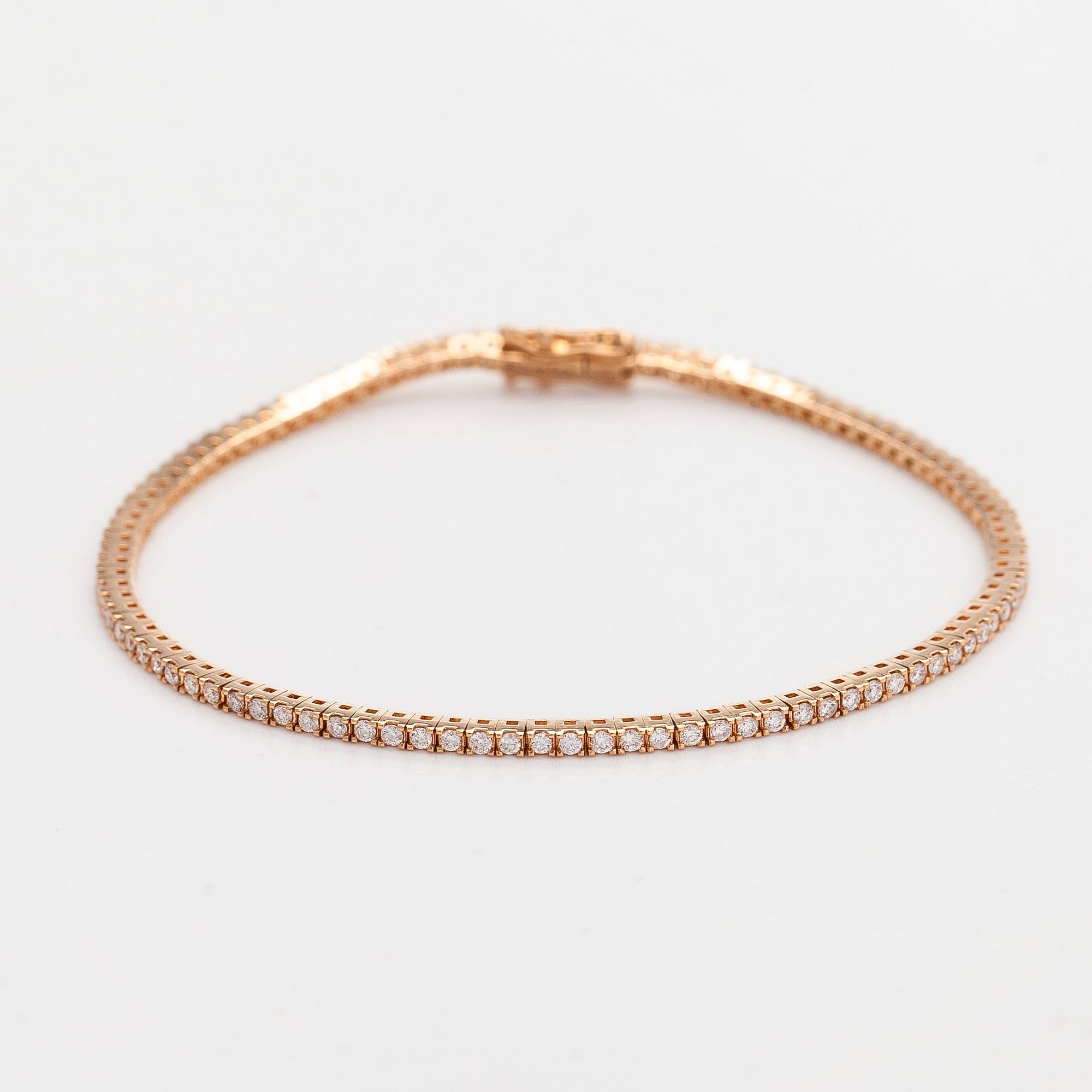An 18K rose gold tennis bracelet with brilliant cut diamonds.
