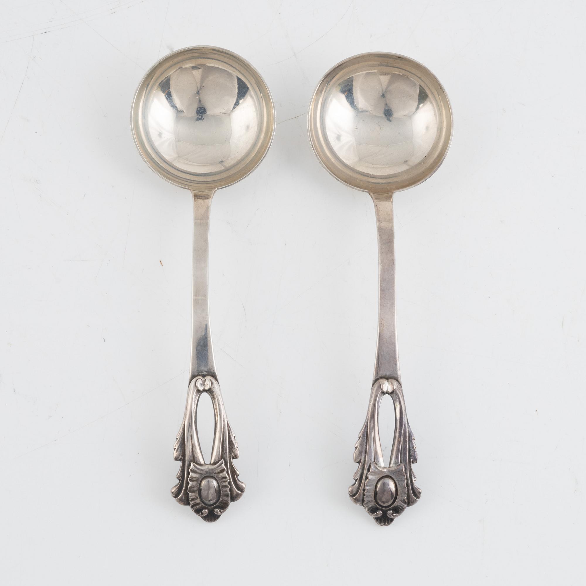 A pair of Swedish Rococo style sterling silver sauce tureens with lid and spoons, mark of Wiwen Nilsson, Lund 1947-1948.