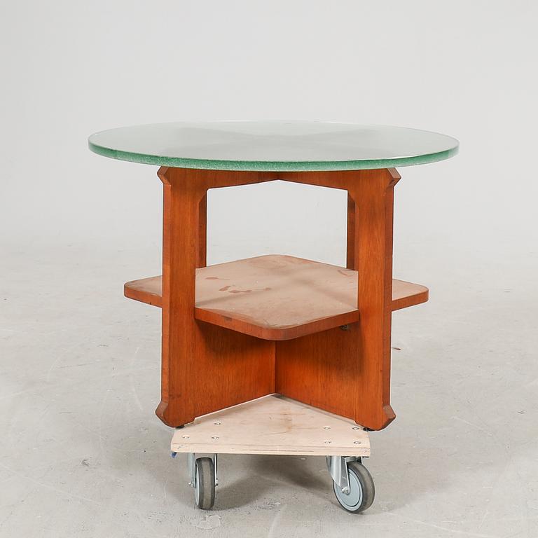 A 1940s wood and glass coffee table.