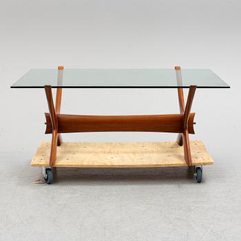 A glass top coffee table by Fredrik Schriever Abeln.