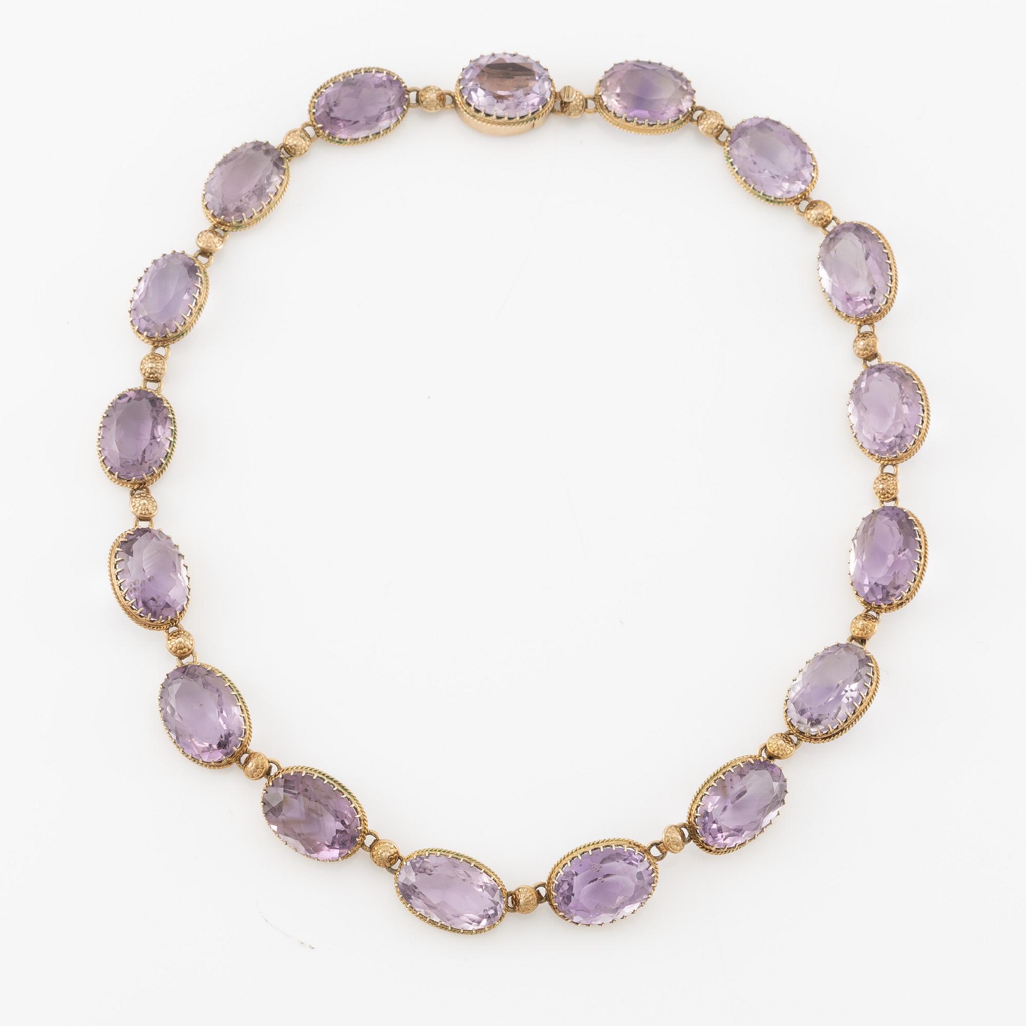 A set with a necklace, a bracelet, a brooch, and a ring.