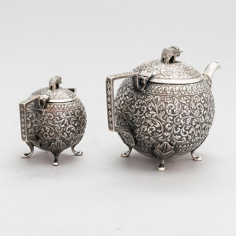 A silver teapot and milk jug, around the turn of the 20th century.