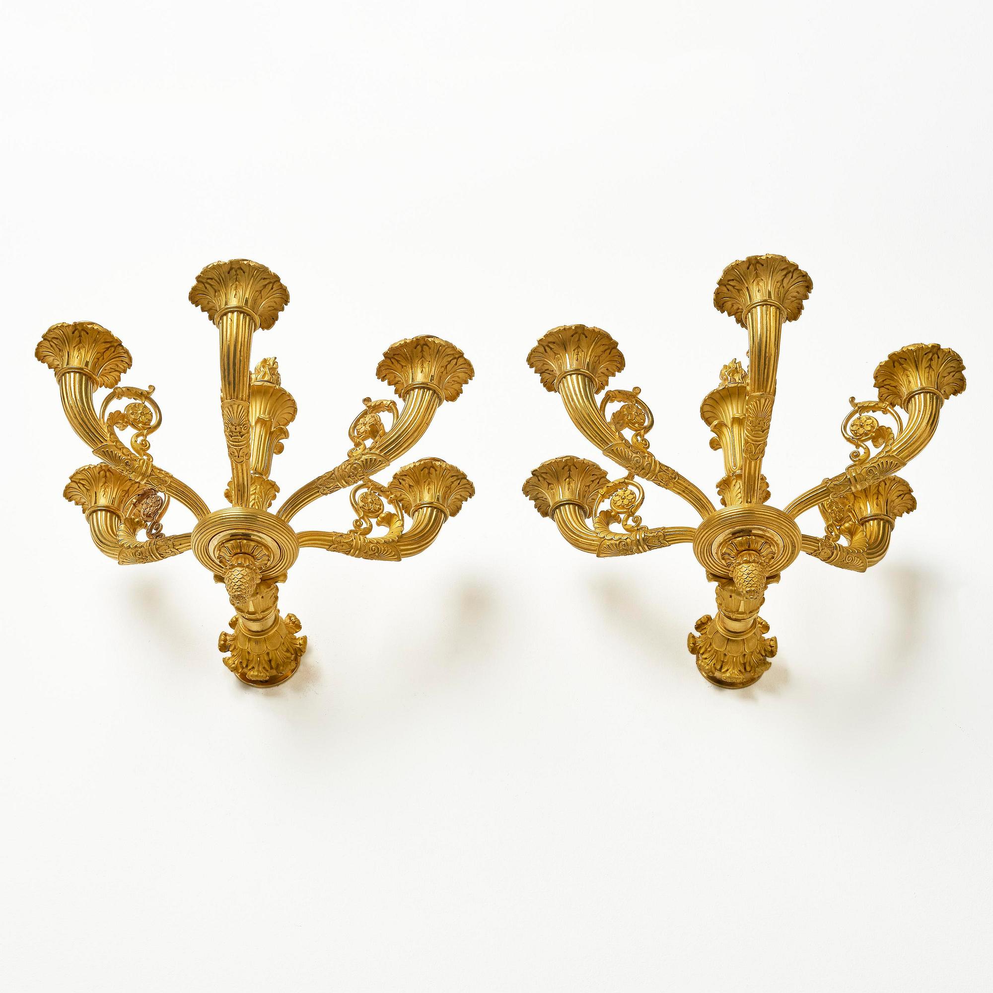 A pair of French Empire six-branch ormolu appliques, ca 1820's.
