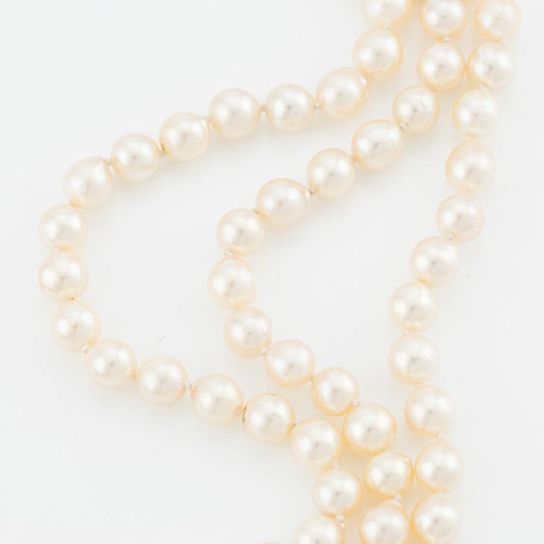 Necklace, three-strand, cultured pearls, clasp by Carlman 18K white gold with cabochon-cut emerald, pearls, and diamonds.