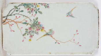 A set with four Chinese porcelain panels with a wooden frame, first half of 20th century.