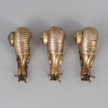 A set of three silver gilt salt-cellars, unmarked.