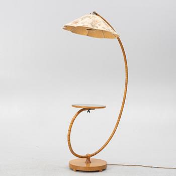 A 1930's/40's floor lamp with table.
