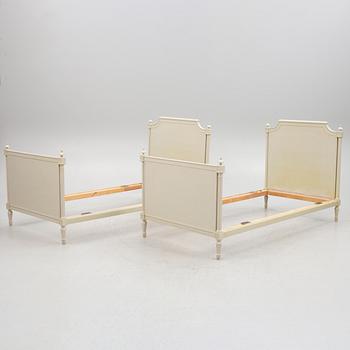 A pair of Gustavian style bed frames, late 20th Century.