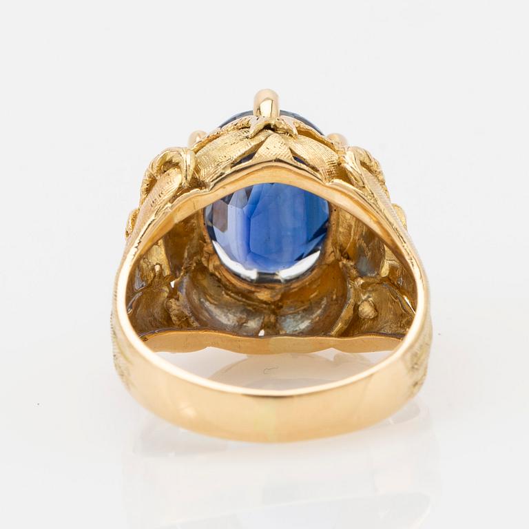 Ring, 18k gold with blue stone, possibly sapphire.