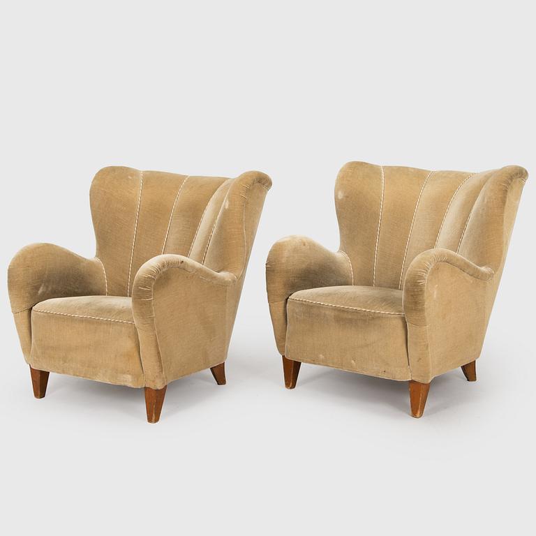 A pair of mid-20th century armchairs.