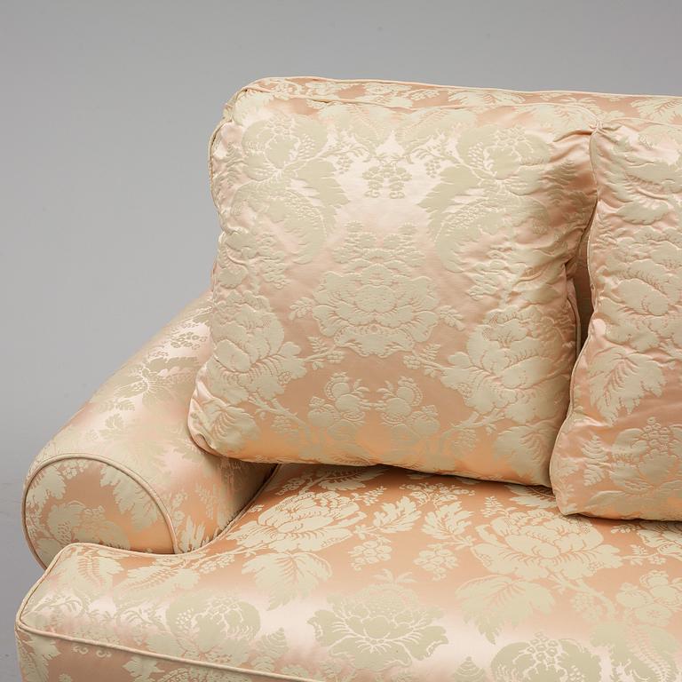 A sofa upholstered with silk damask.