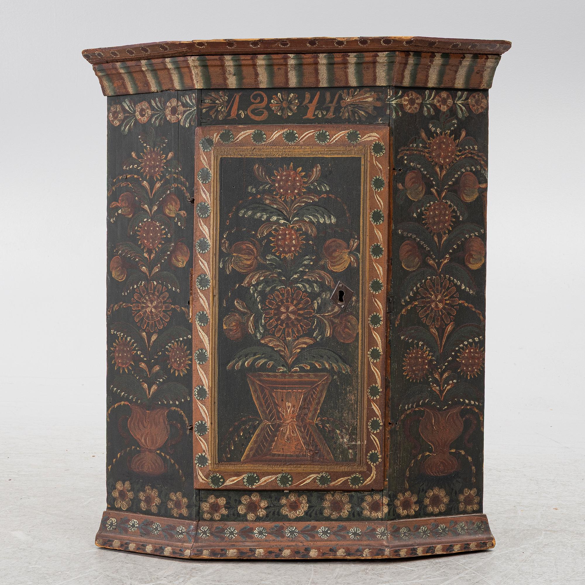 A corner hanging cabinet, dated 1844.