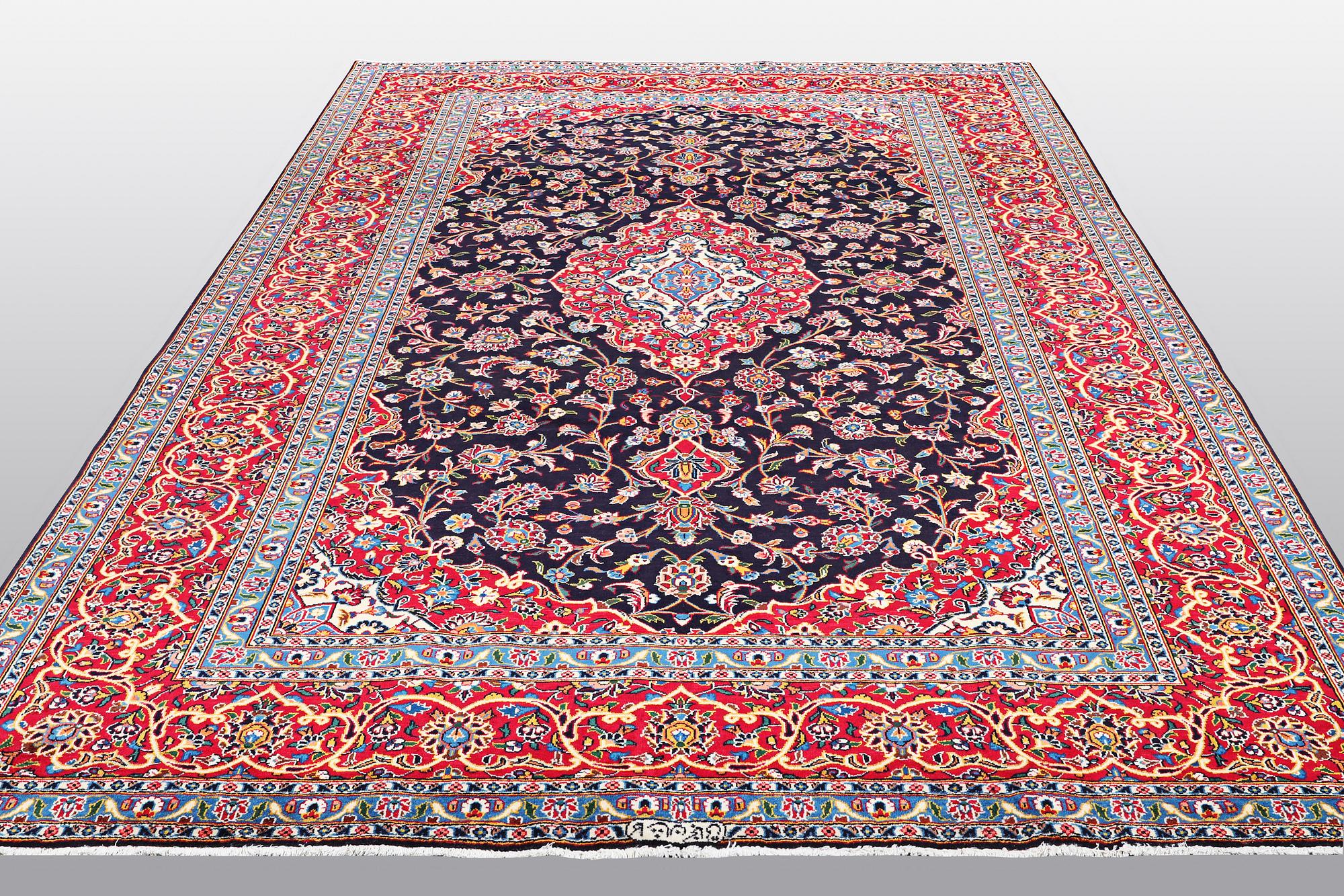 A carpet, Kashan signed Najafi, ca 360 x 231 cm.