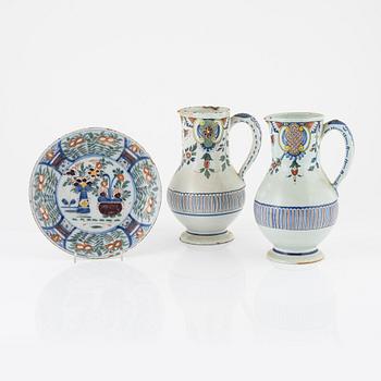 Two earthenware pitchers and one plate, Holland, 18th-19th century.