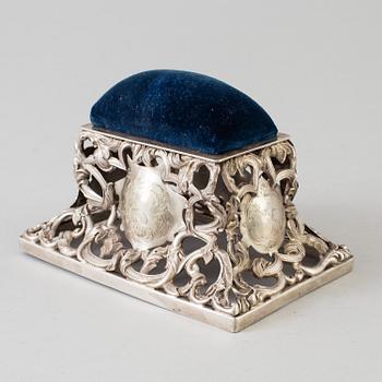 A Swedish 19th century silver pincushion and an English early 20th century pinstand.