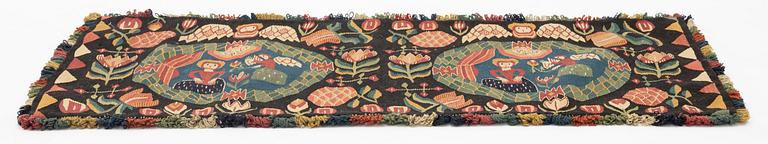 A carriage cushion, 'the Annunciation', tapestry weave, c. 100 x 48 cm, southwestern Scania, Sweden.