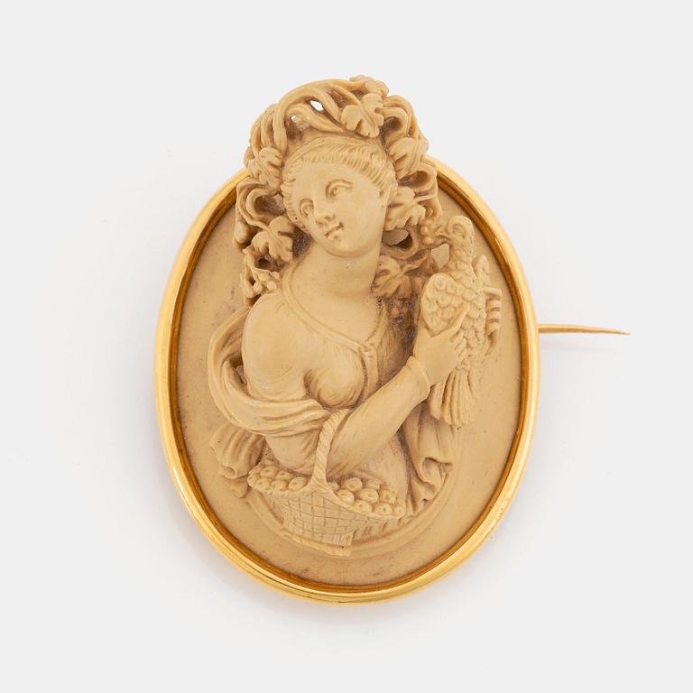 An 18K gold and lava cameo brooch.