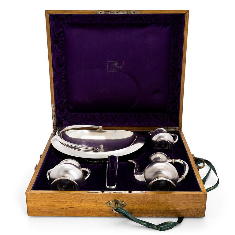 A four-piece silver coffee set, St. Petersburg 1887, original fitted box from Khlebnikov. Sugar tong, Moscow around 190.