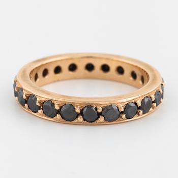 A brilliant cut black diamond ring.