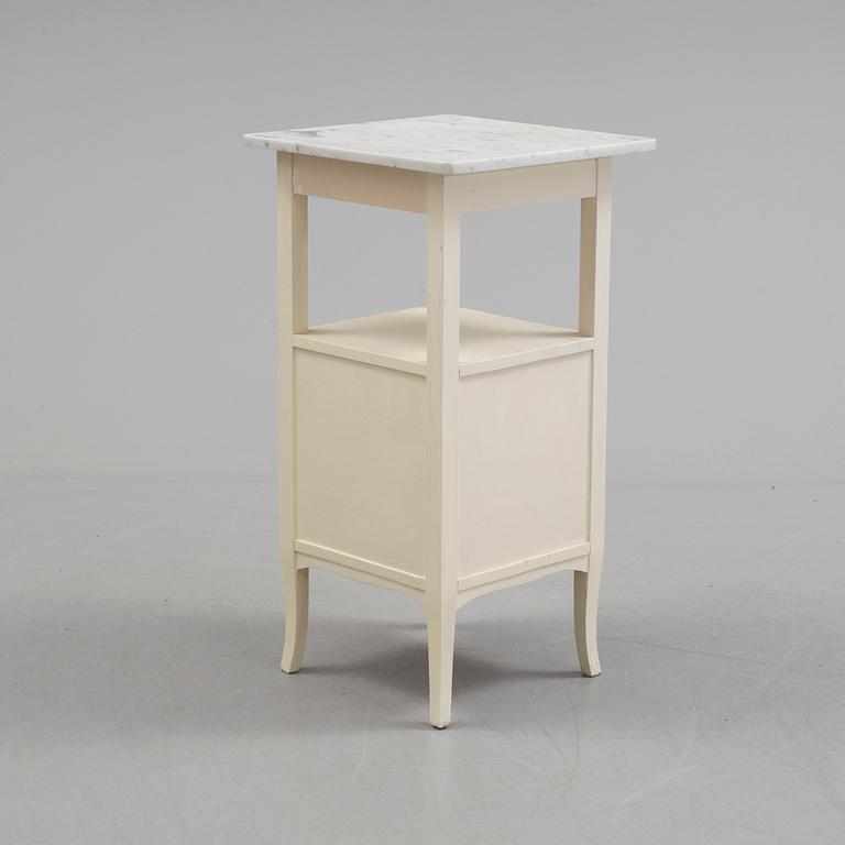A early bedside table with marble top.