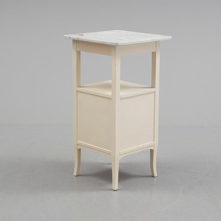 A early bedside table with marble top.