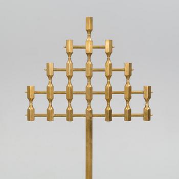 A brass floor candelabrum from Metallslöjden Gusum, signed BK and dated 1989.
