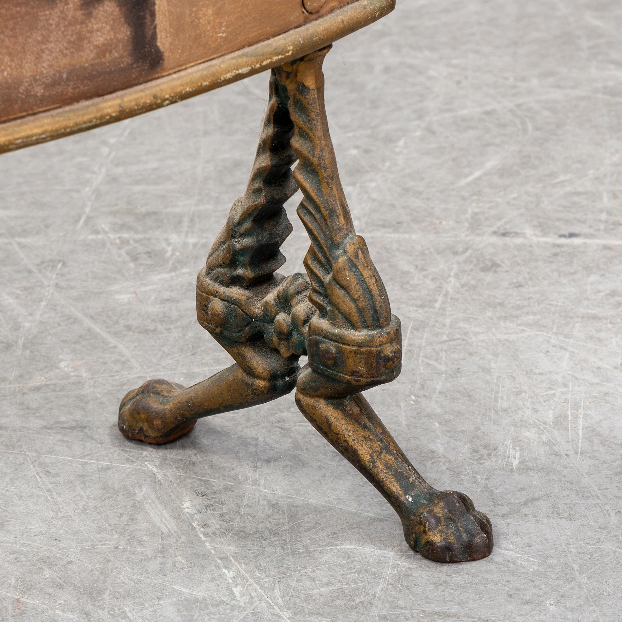 A 19th century brass fire shield decorated with paint of hunting dog setter in the stable.