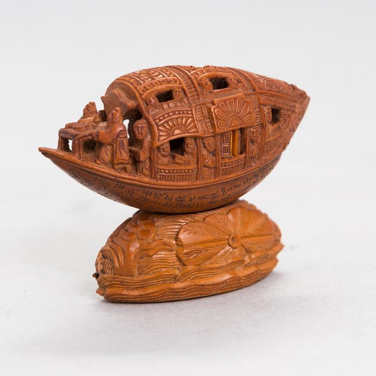 A Chinese nut boat sculpture, with poem.