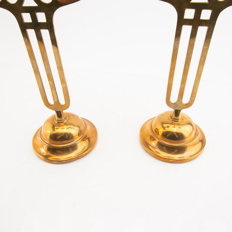 A öair of brass candelabras 20th century.