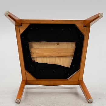 A dining table with four chairs, mid 20th century.