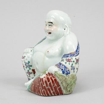 A seated famille rose decorated porcelain buddha, 20th century.