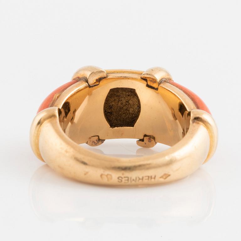 An 18K gold and coral Hermès ring.