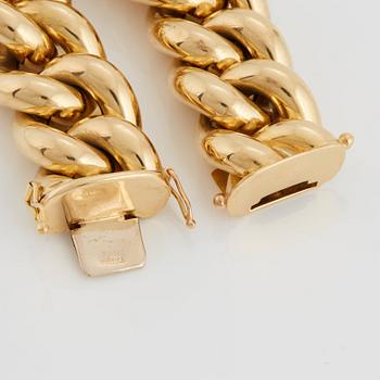 A curb link bracelet in 18K gold.