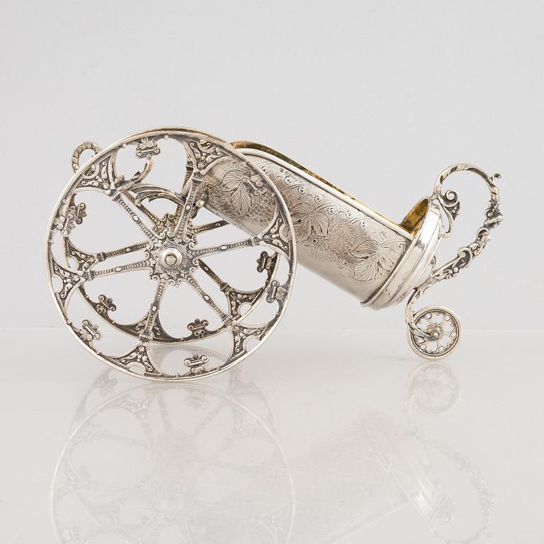A silver bottle holder with wheels, 20th Century.