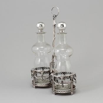 A silver bottle holder with glass bottles, possibly from Holland. From around year 1900.