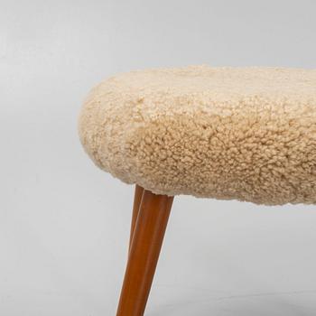 A stool with stained beech wood legs and new sheepskin upholstery, second part of the 20th Century.