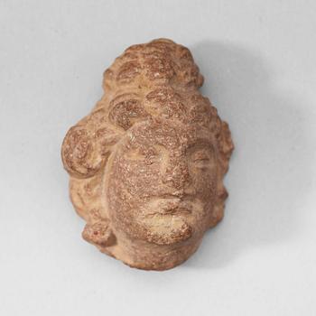 120. A miniature schist scultpure of a head, Gandhara, 2nd/3rd Century.