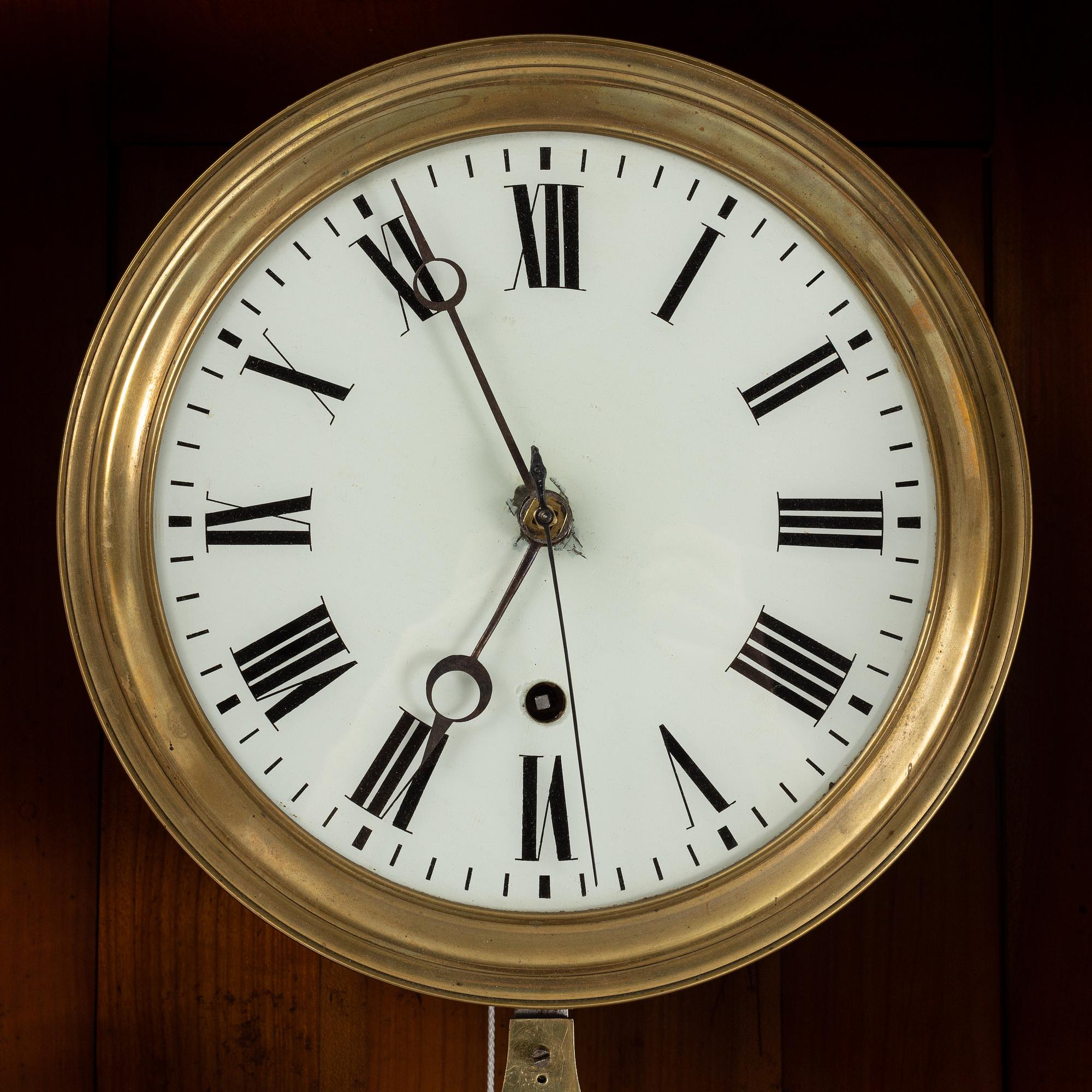 A walnut long case clock, from around the year 1900.