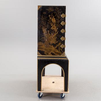 AN early 18TH CENTURY PROBABLY ENGLISH Japanned laquer cabinet on stand.