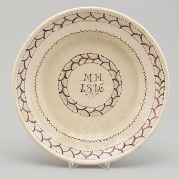 An faience dish dated 1816.