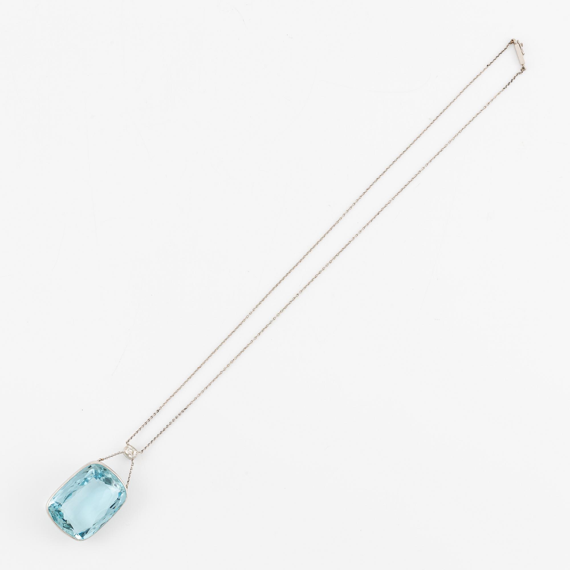 A platinum necklace with a faceted aquamarine and an oval old-cut diamond.